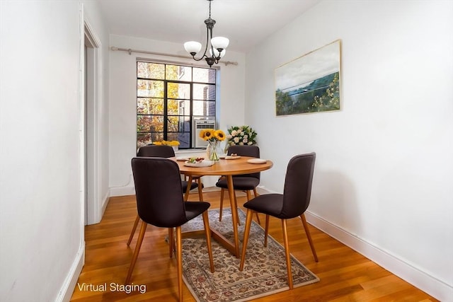 dining room with a chandelier and wood-type flooring