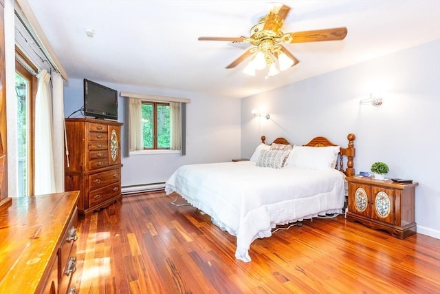 bedroom with a baseboard radiator, a ceiling fan, and wood finished floors