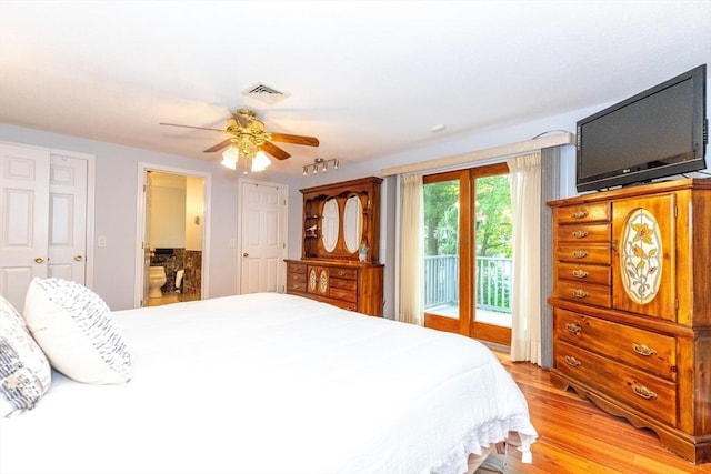 bedroom featuring access to outside, ceiling fan, ensuite bathroom, light wood-type flooring, and visible vents