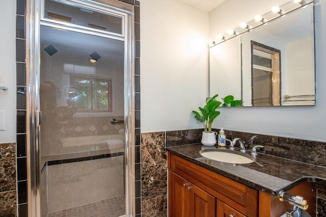 full bathroom with a shower stall and vanity