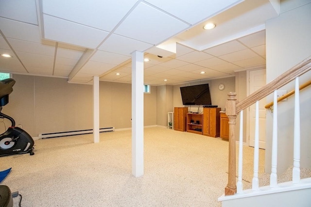 finished basement featuring a baseboard heating unit, carpet, stairway, and recessed lighting