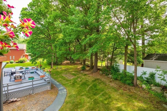 view of yard with a deck and fence