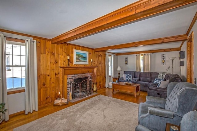 living room featuring a brick fireplace, hardwood / wood-style flooring, beamed ceiling, and wood walls