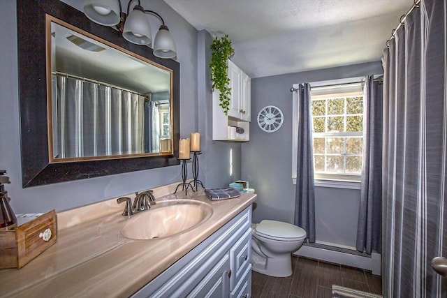 bathroom with vanity, hardwood / wood-style floors, and toilet