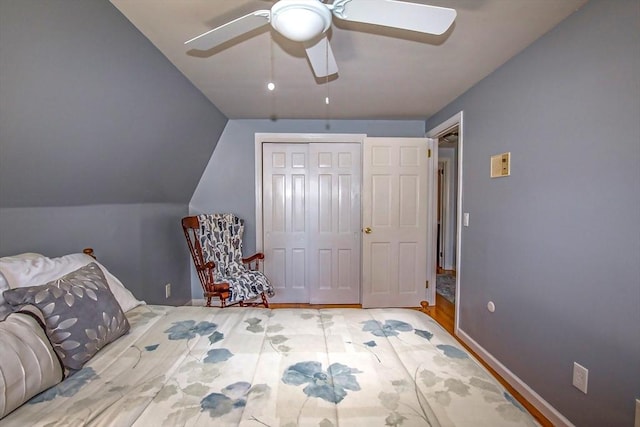 unfurnished bedroom featuring ceiling fan, lofted ceiling, and a closet