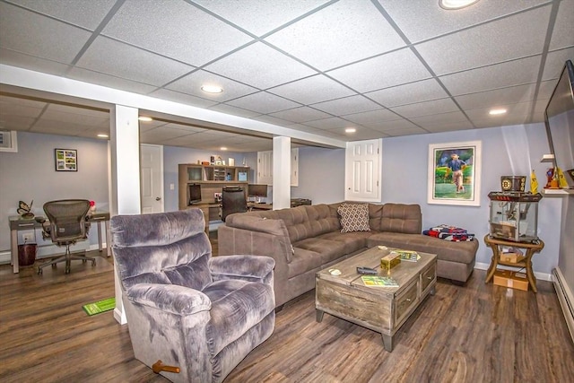 living room with a baseboard radiator, dark hardwood / wood-style floors, and a paneled ceiling