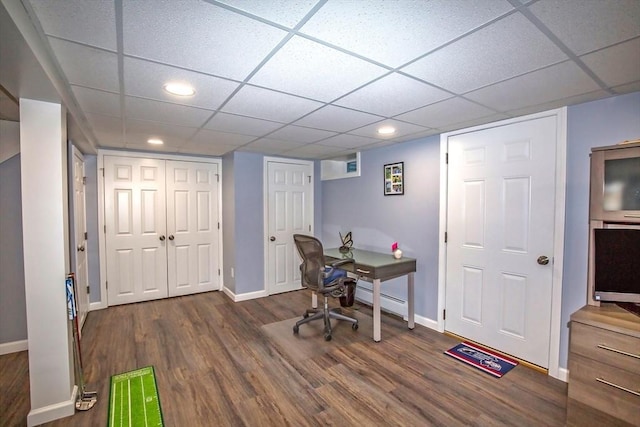 office space with dark wood-type flooring and a drop ceiling