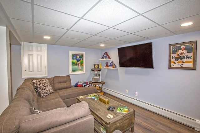 living room with wood-type flooring, a paneled ceiling, and baseboard heating