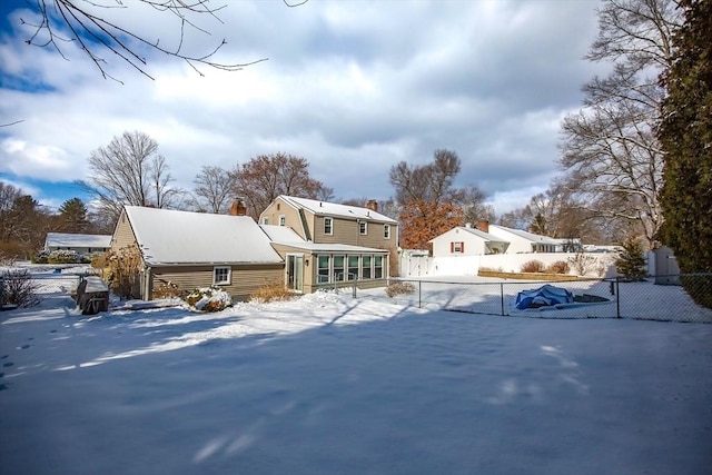 view of snow covered back of property