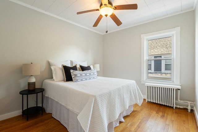 282 Palmer St, New Bedford, MA 02740 - bedroom featuring radiator heating unit, ornamental molding, wood-type flooring, baseboards, and a ceiling fan