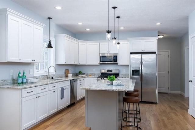 kitchen with white cabinets, stainless steel appliances, and a sink