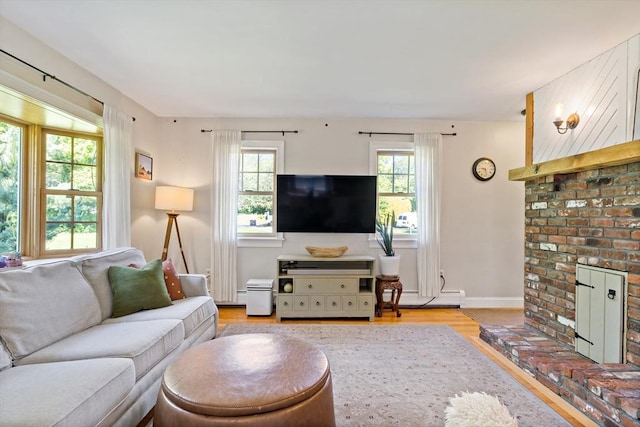 31 Blanding Rd, Rehoboth, MA 02769 - living room featuring plenty of natural light, light wood-style floors, baseboard heating, and a brick fireplace