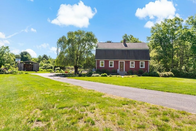 31 Blanding Rd, Rehoboth, MA 02769 - dutch colonial with a detached carport, asphalt driveway, a front lawn, and a chimney