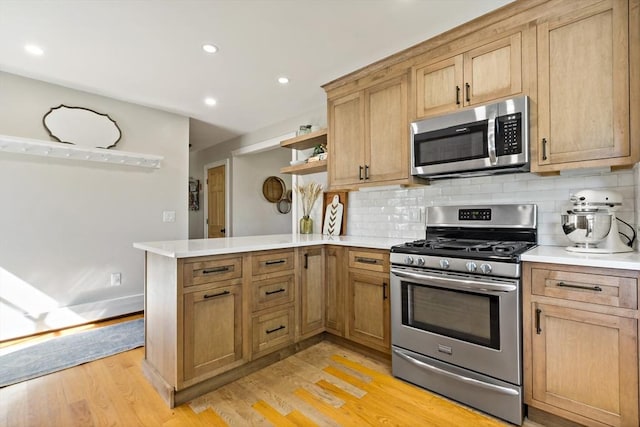 31 Blanding Rd, Rehoboth, MA 02769 - kitchen with appliances with stainless steel finishes, a peninsula, open shelves, light wood-style floors, and decorative backsplash