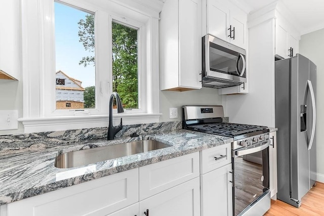 106 Pond St Unit U 30, Attleboro, MA 02703 - kitchen with stainless steel appliances, a sink, and white cabinets