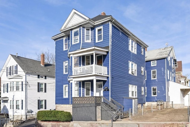 view of front of home featuring a balcony and covered porch