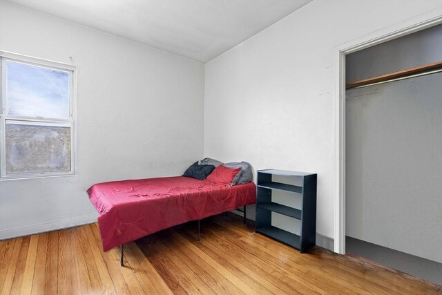 bedroom with hardwood / wood-style flooring and a closet