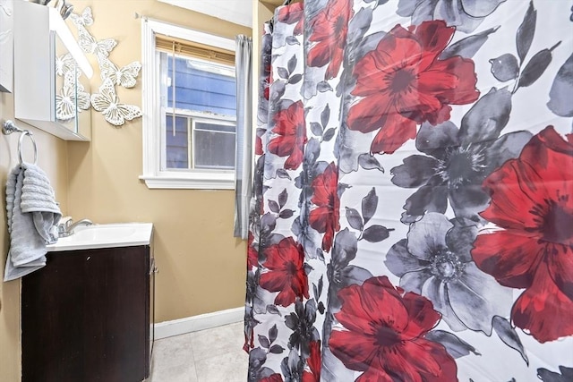 bathroom with tile patterned flooring, vanity, and curtained shower