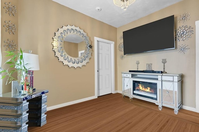 living room with hardwood / wood-style floors and a notable chandelier