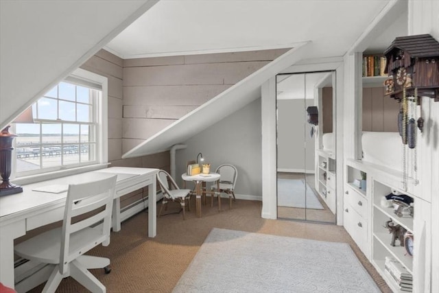 office area featuring light carpet and wooden walls