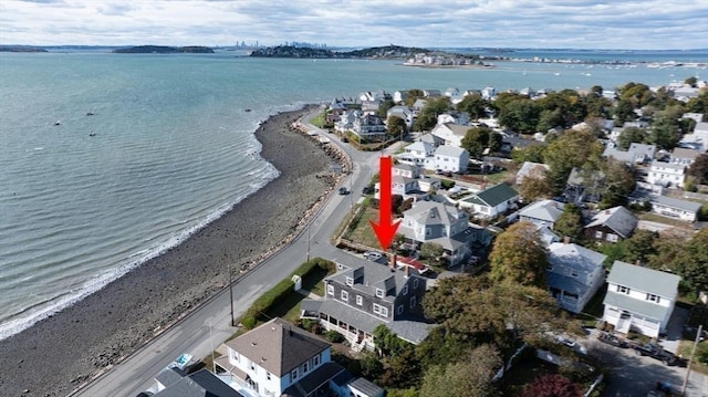 birds eye view of property with a water view and a view of the beach