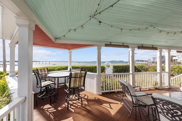 wooden deck featuring a water view