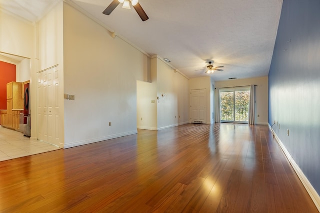 unfurnished room with light wood-type flooring, a textured ceiling, ceiling fan, and crown molding