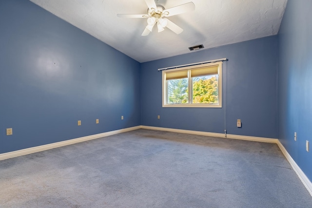 carpeted spare room featuring ceiling fan and vaulted ceiling