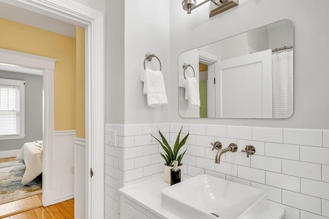 12 Highland Ave Unit 1, Arlington, MA 02476 - full bathroom with a sink, wainscoting, and wood finished floors