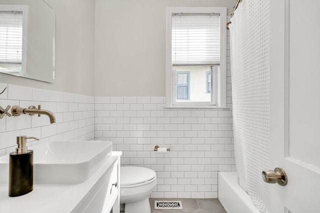 12 Highland Ave Unit 1, Arlington, MA 02476 - bathroom featuring toilet, tile walls, wainscoting, and visible vents