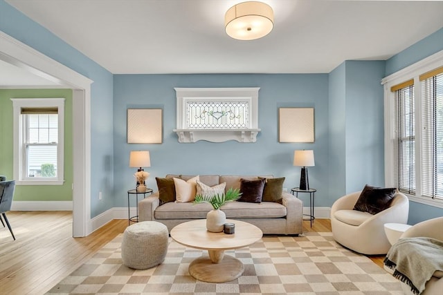 12 Highland Ave Unit 1, Arlington, MA 02476 - living area featuring baseboards, plenty of natural light, and light wood finished floors