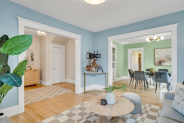 12 Highland Ave Unit 1, Arlington, MA 02476 - living area with baseboards, a notable chandelier, and light wood finished floors