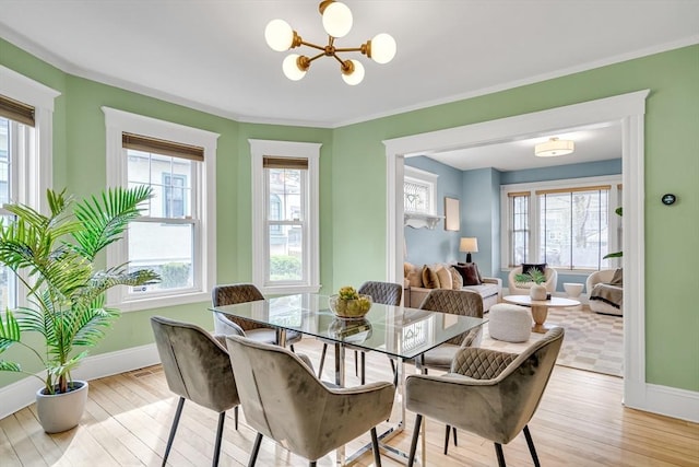12 Highland Ave Unit 1, Arlington, MA 02476 - dining room with light wood-type flooring, ornamental molding, baseboards, and a chandelier