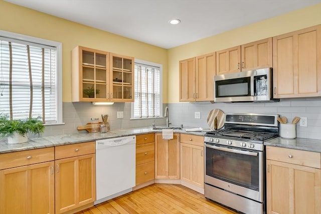 12 Highland Ave Unit 1, Arlington, MA 02476 - kitchen with appliances with stainless steel finishes, light wood-type flooring, a sink, and light brown cabinets