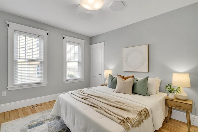 12 Highland Ave Unit 1, Arlington, MA 02476 - bedroom featuring baseboards, visible vents, and wood finished floors
