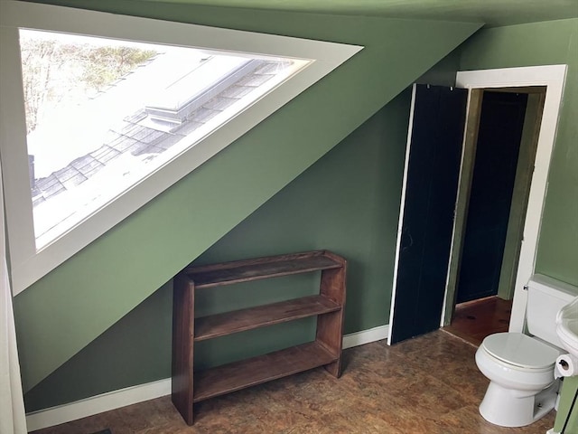 interior space with a skylight and baseboards