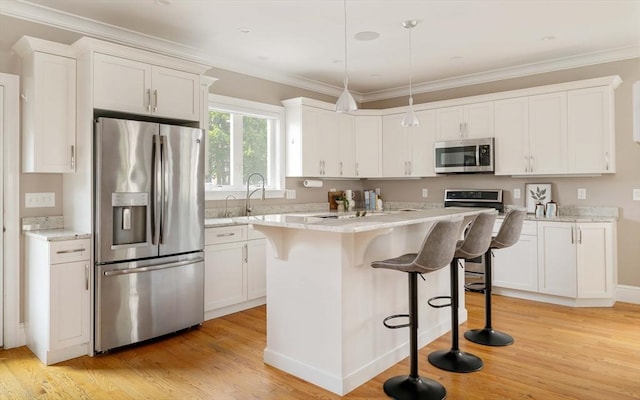 31 Neponset Ave, Boston, MA 02131 - kitchen with appliances with stainless steel finishes, light wood-style flooring, white cabinetry, a kitchen bar, and ornamental molding