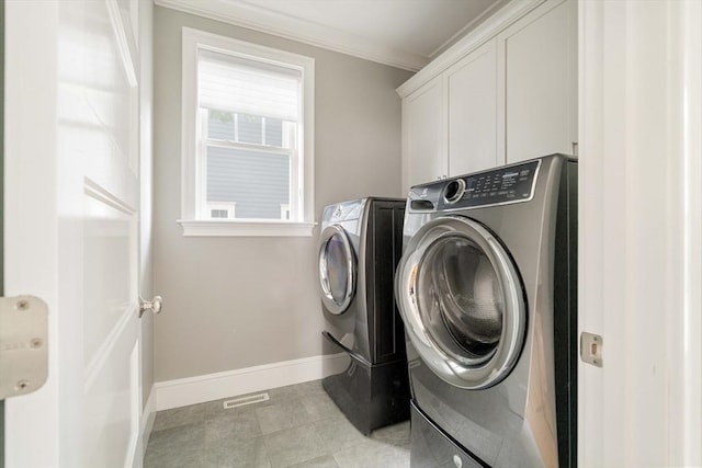 31 Neponset Ave, Boston, MA 02131 - washroom featuring washing machine and dryer, cabinet space, crown molding, and light tile patterned floors