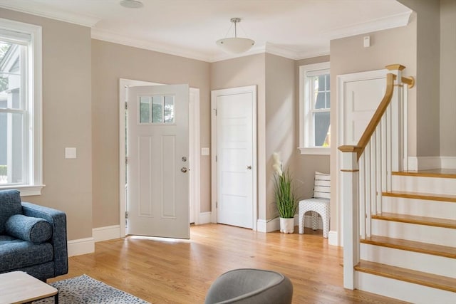 31 Neponset Ave, Boston, MA 02131 - entryway with healthy amount of natural light, light wood-style floors, stairs, and ornamental molding