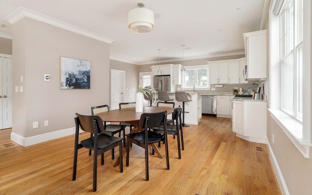 31 Neponset Ave, Boston, MA 02131 - dining room featuring light wood-style floors and crown molding