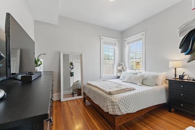 bedroom featuring baseboards and light wood-style floors