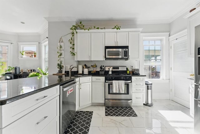 kitchen featuring plenty of natural light, marble finish floor, and appliances with stainless steel finishes