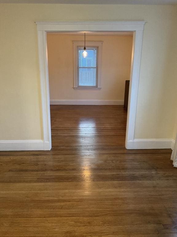 unfurnished room with dark hardwood / wood-style flooring