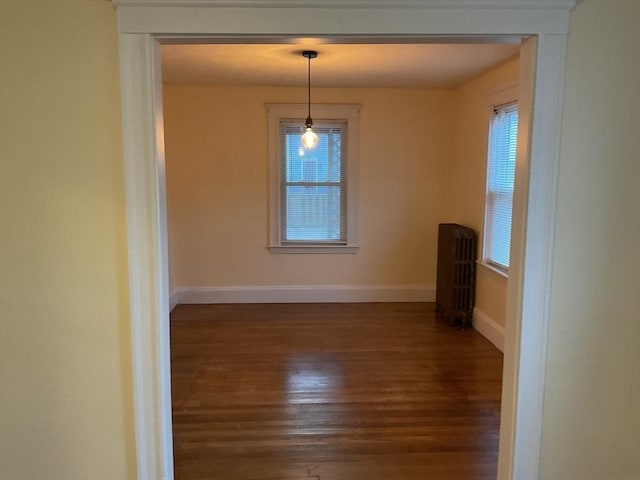 56 Riverview St, Dedham, MA 02026 - unfurnished dining area with dark wood-type flooring, baseboards, and radiator heating unit