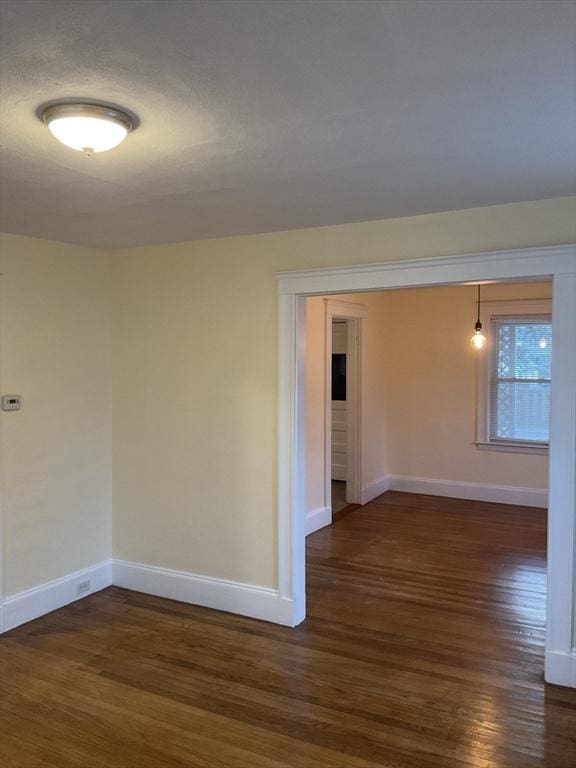 56 Riverview St, Dedham, MA 02026 - unfurnished room featuring dark wood-style flooring and baseboards