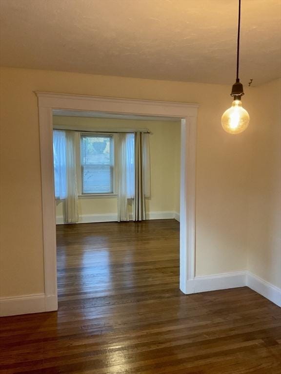 spare room featuring dark hardwood / wood-style floors