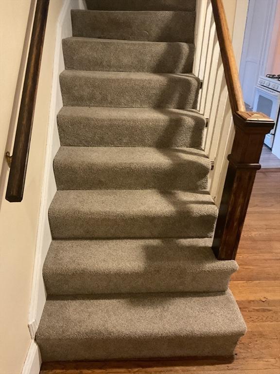 56 Riverview St, Dedham, MA 02026 - stairs featuring wood finished floors