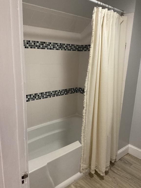 bathroom featuring hardwood / wood-style flooring and shower / bath combo