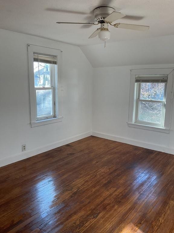 bonus room featuring lofted ceiling, dark wood-type flooring, and a healthy amount of sunlight