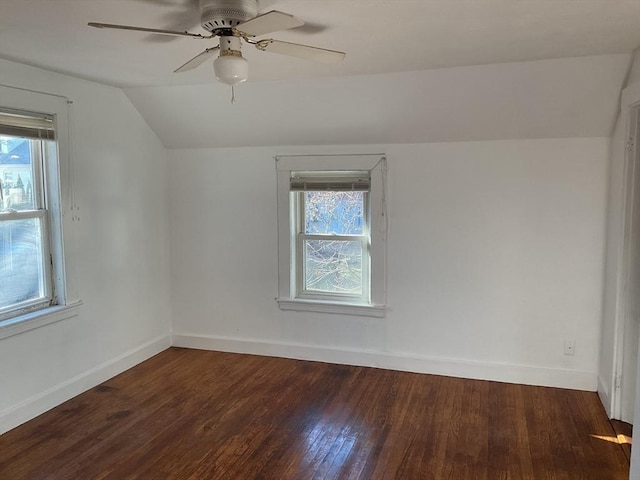 unfurnished room with ceiling fan, dark wood-type flooring, a healthy amount of sunlight, and lofted ceiling